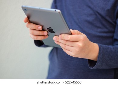 Minsk, Belarus - November 25, 2016: Teenager boy absorbedly playing a computer game on iPad Apple. Social network.