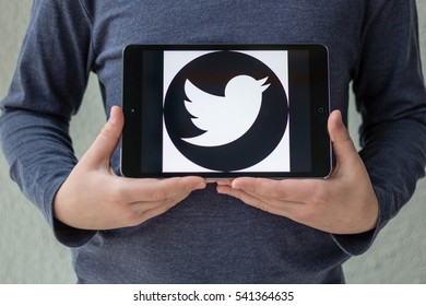 Minsk, Belarus - November 25, 2016:Teenager Shows On IPad Apple Twitter Logo White Bird On A Black Background.