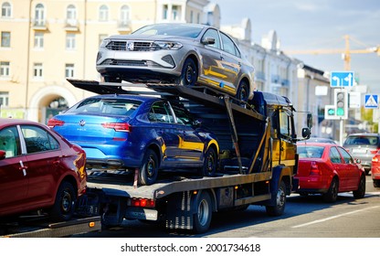 Minsk, Belarus. Oct 2020. Hauling new VW Polo cars to dealership. Car carrying trailer transporting VW sedan cars at city street.