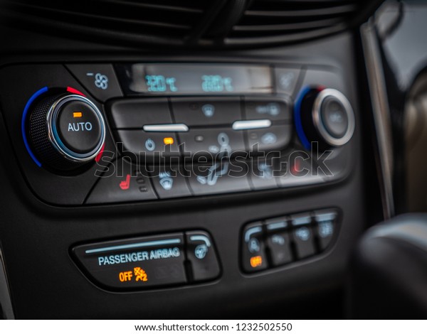 MINSK, BELARUS -\
OCTOBER 25, 2018: Climate control unit of a modern SUV Ford Escape.\
Climate system allows separate temperature adjustement for driver\'s\
and passenger\'s side.