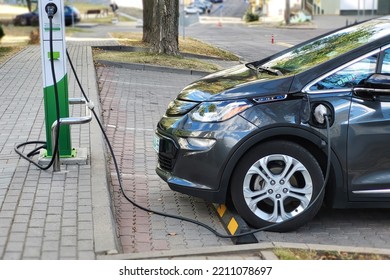 Minsk, Belarus. Sep 2022. Chevy Bolt EV Electric Car Charging At Public Charging Station. EV Vehicle Plugged, Fill Up Electric Fuel From Power Station. Chevrolet Car Charging. Mobile Phone Photo