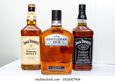 Minsk, February 20, 2021: Three bottles of American Tennessee Jack Daniels whiskey - Tennessee Honey, Number 7, Gentleman Jack on a light background.