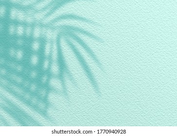 Mint Blue cement texture wall leaf plant shadow background.Summer tropical travel beach with minimal concept. Flat lay pastel color palm nature.