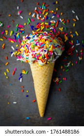 Mint chocolate chip ice cream cone with sprinkles