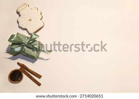Mint colored gift box with satin ribbon gingerbread angel and cinnamon sticks
