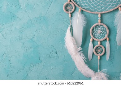 Mint cream dream catcher on turquoise textured background. Texture of concrete. 