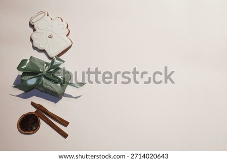 Mint gift box decorated with gingerbread angel cinnamon sticks and dried orange slice