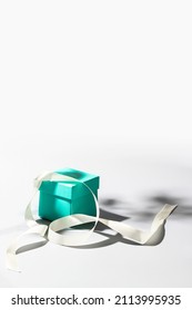 Mint Green Gift Box And  Silk Ribbon On White Background With Shadow.Copy Space