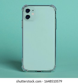 Mint Green IPhone 11 In Clear Silicone Case Back View. Phone Case Mockup Isolated On Green Background Close Up