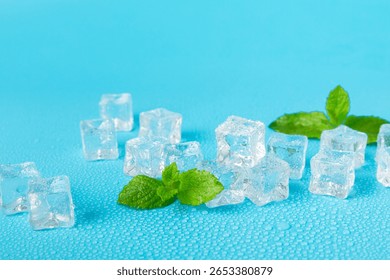 Mint and ice on texture background. Green fresh mint and ice cube. Mint leaves, ice cube and water drops for cold drink. Top view. Space for text. Copy space.