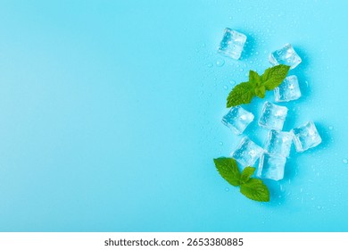 Mint and ice on texture background. Green fresh mint and ice cube. Mint leaves, ice cube and water drops for cold drink. Top view. Space for text. Copy space.