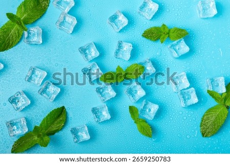 Mint and ice on texture background. Green fresh mint and ice cube. Mint leaves, ice cube and water drops for cold drink. Top view. Space for text. Copy space.