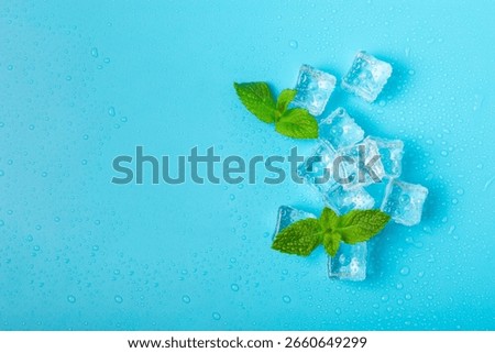 Mint and ice on texture background. Green fresh mint and ice cube. Mint leaves, ice cube and water drops for cold drink. Top view. Space for text. Copy space.