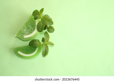 Mint Leaves And Jelly Candy On Color Background