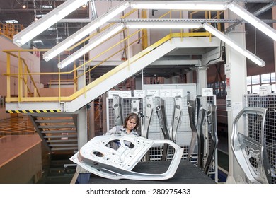 Mioveni, Romania - October 13, 2014: Color Picture Of Workers On The Assembly Line Of The Dacia Renault Factory.