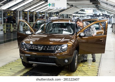 Mioveni, Romania - October 13, 2014: Color Picture Of A Worker On The Assembly Line Of The Duster Model At The Dacia Renault Factory.