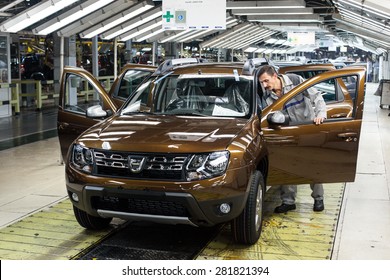 Mioveni, Romania - October 13, 2014: Color Picture Of A Worker On The Assembly Line Of The Duster Model At The Dacia Renault Factory.