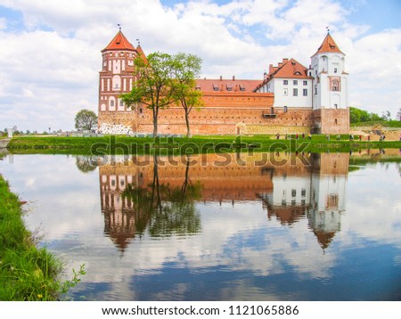 Mir, Belarus. Castle Complex Mir On Sunny Day with blue sky Background. Old medieval Towers and walls of traditional fort from unesco world heritage list