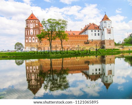 Mir, Belarus. Castle Complex Mir On Sunny Day with blue sky Background. Old medieval Towers and walls of traditional fort from unesco world heritage list