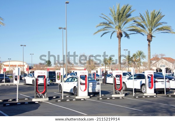 Mira Loma,\
CA - Jan 24, 2022: Tesla supercharging station in Home Depot store\
parking lot.\
Tesla Supercharger stations allow Tesla cars to be\
fast-charged at the network within an\
hour.