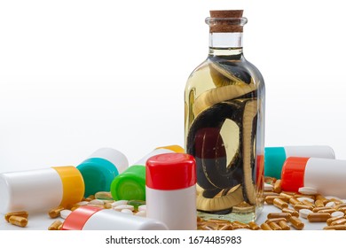 Miracle Cure, Homeopathy, Alternative Medicine And Pretend Remedy Concept With Glass Jar Of Snake Oil, Many Homeopathic Pill Bottles And Supplement Pills And Capsules Isolated On White Background