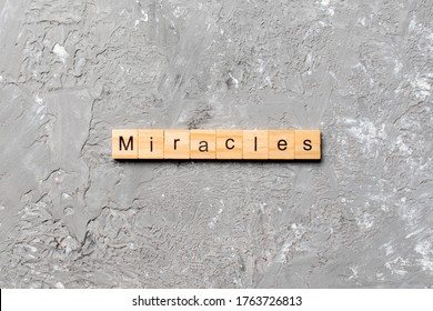The miracles word written on wood block. miracles text on cement table for your desing, concept.