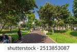 Miraflores central park timelapse hyperlapse Place for relax with green trees and lawn in Peruvian capital. People sitting on benches and walking around. Lima, Peru