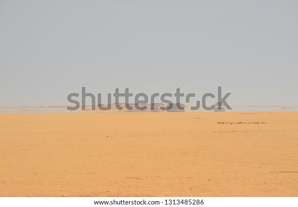 A mirage is a naturally\
occurring optical phenomenon in which light rays bend to produce a\
displaced image of distant objects or the sky. Mirage at Arabian\
Desert.