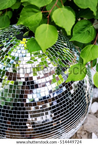  Mirror Disco ball close up on a background of green leaves in the club Stock photo © 