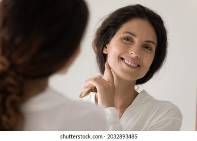 Mirror Head Shot Reflection Happy Beautiful Young Latina Hispanic Woman Looking At Camera, Feeling Satisfied With Perfect Skin After Morning Skincare Routine Or Professional Cosmetology Services.