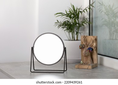 Mirror, Holder With Jewelry And Houseplant On Light Grey Stone Window Sill