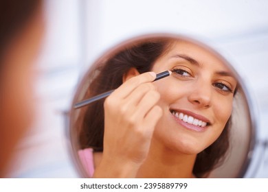 Mirror, makeup and happy woman with eyeliner, pencil or application in a home bathroom with morning routine. Face, beauty and female person with eye, color or shape, aesthetic or cosmetic treatment