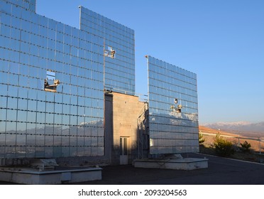 Mirror panels reflecting a mountain view in Parkent, Uzbekistan