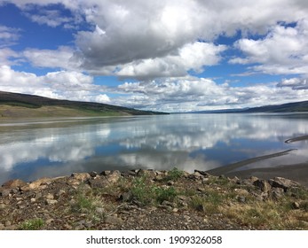 Mirror Reflection Of The Clouds Made Possible By The Lake In Iceland