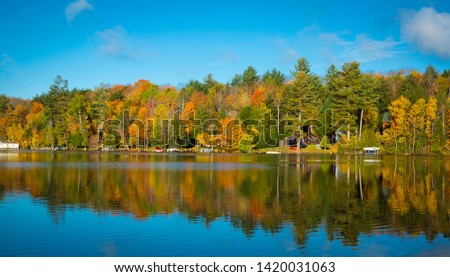 Mirror reflection during fall on lake saranac