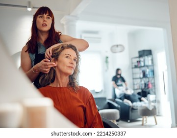 Mirror reflection of senior woman, hairdresser and salon studio employee working on client haircut, hair care or treatment. Designer hair salon, beauty spa service and stylist work on customer hair - Powered by Shutterstock