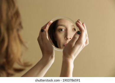 Mirror reflection of a woman's face, studio shot