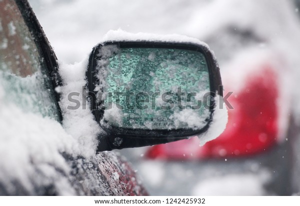 A mirror\
of a snow covered car shown in\
Montreal