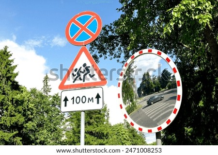 Mirror of spherical type reflecting the cross for improving visibility and road signs Stopping is prohibited and Caution Children