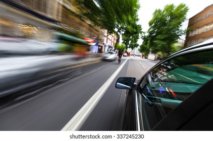 Mirror View Of Speeding Car.