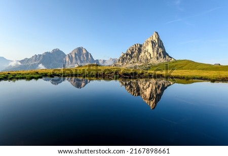 Mirror water of a lake in a mountain valley. Mountain lake reflection