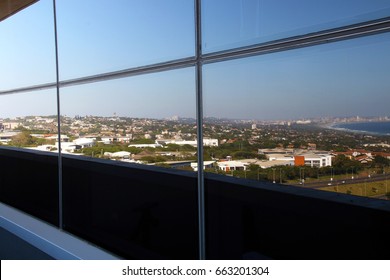 Mirrored Reflection Of Urban City Landscape On Glass Facade On Balcony Of Commercial Office Block Building In Durban, South Africa