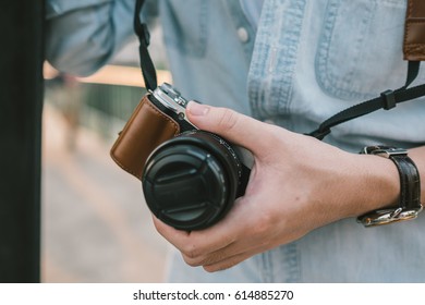 Mirrorless camera held in hand