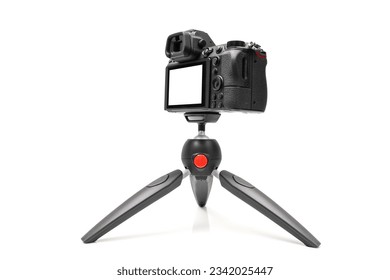 Mirrorless camera on a tripod for live or streaming, mockup camera isolated with clipping path on a white background
