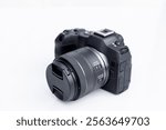 Mirrorless interchangeable lens digital full frame professional photo and video camera with lens.