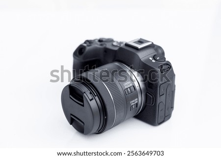 Mirrorless interchangeable lens digital full frame professional photo and video camera with lens.