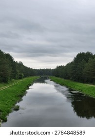 The mirror-like surface of a forest river