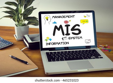 MIS  Management Information System  Data Development Information And MIS Laptop On Table. Warm Tone