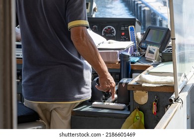 Misaki City, Kanagawa Prefecture, Japan June 30, 2022:The Captain Operating The Fishing Boat And The View Of The Wheelhouse