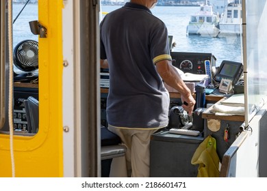 Misaki City, Kanagawa Prefecture, Japan June 30, 2022:The Captain Operating The Fishing Boat And The View Of The Wheelhouse